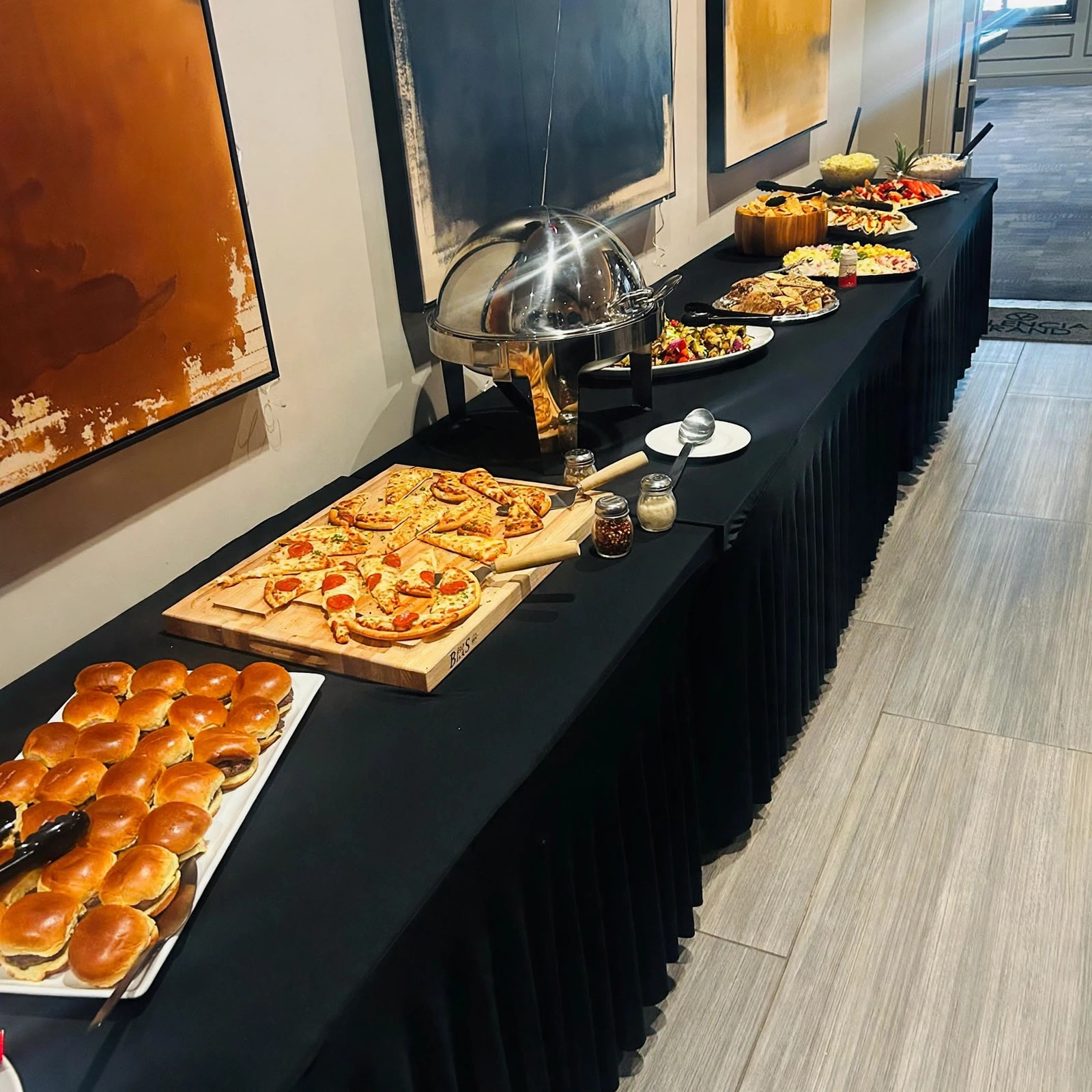 Catering spread with sliders and flatbreads